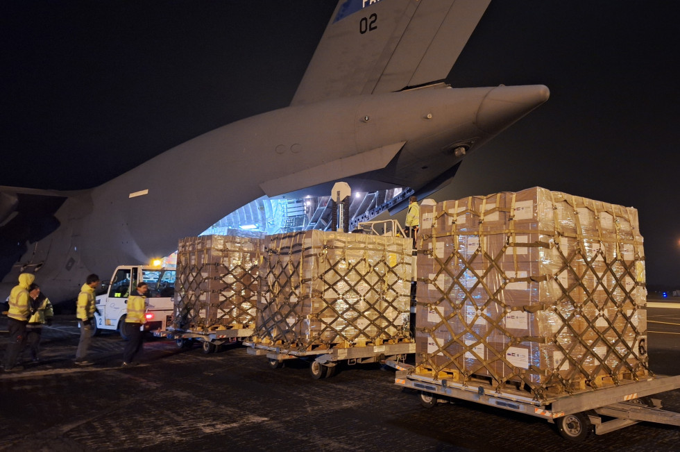 Pallets of humanitarian aid on the tarmac in front of the plane