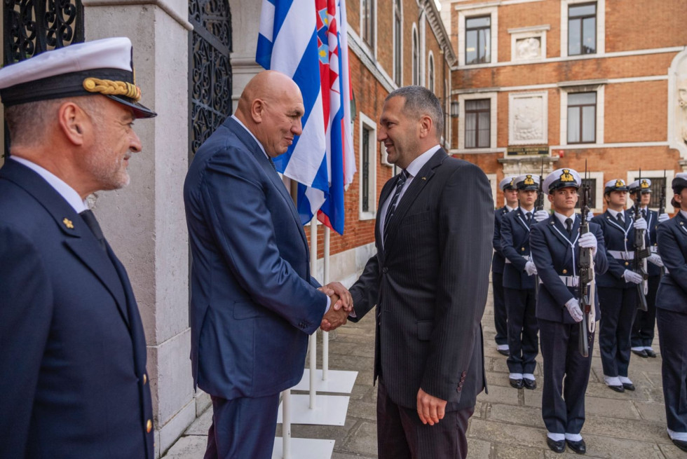 Predsednik in sekretar se rokujeta ob prihodu na slovesnost