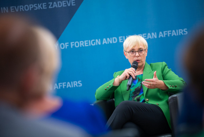 Slovenian president sitting on sofa, holding microphone