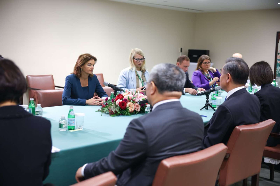 minister Fajon sitting on the opposite side of chinese minister