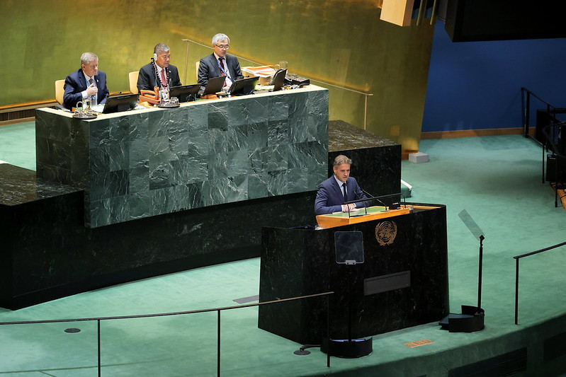 man behind lectern distant view