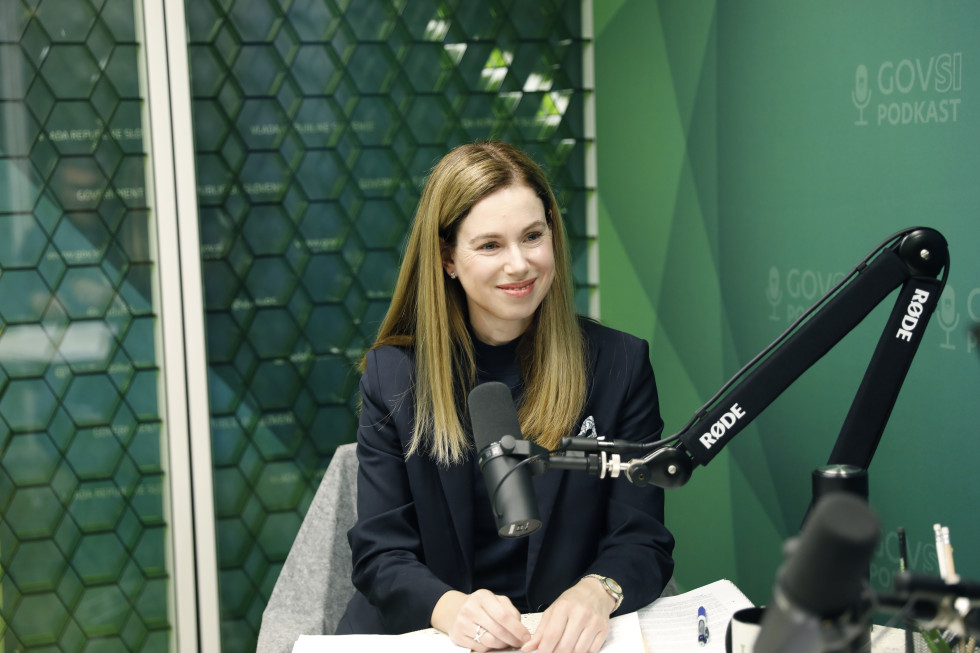 Yooung woman sitting at a table with microphone